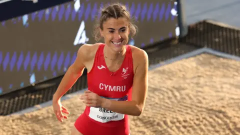Olivia Breen smiles after a jump