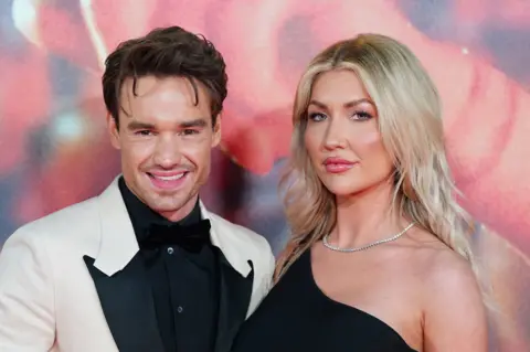 PA Media Liam Payne and Kate Cassidy standing together facing the camera