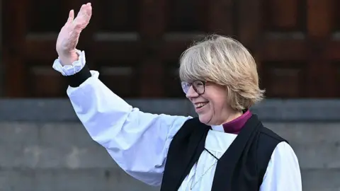 Getty Images The new Archbishop of Canterbury Sarah Mullally waves from the steps of St Paul's Cathedral after taking part in a 'Confirmation of Election' ceremony in London