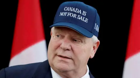 Doug Ford wearing cap saying 'Canada is not for sale'