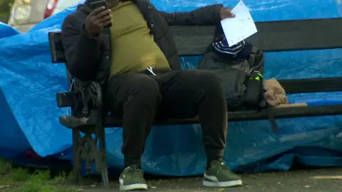 Asylum seeker sat on bench in Dublin