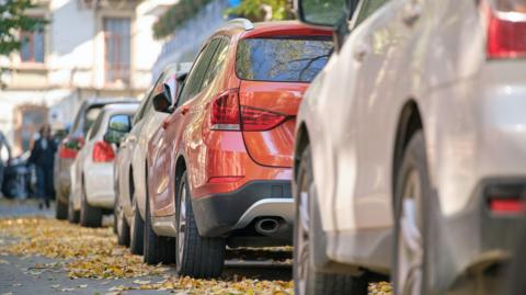 Stock image of cars parked along a street