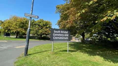 BBC The front entrance to South Bristol Cemetary and Crematorium on a sunny day
