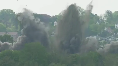 Clouds of dirt fly into the air as a WW2 bomb is detonated in Plymouth
