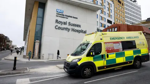 An ambulance drives past the Royal Sussex County Hospital in Brighton