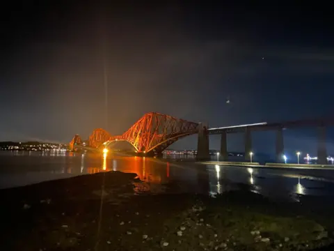 Susanne McNaught The red Forth Rail Bridge lit up at night