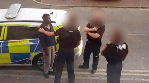 Supplied Calocane being spoken to by police outside Brook Court in May 2020.