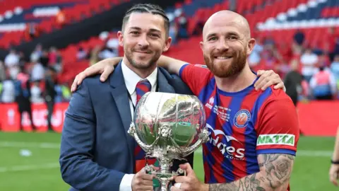 Aldershot Town Harfield at Wembley with the FA Trophy in 2025. 