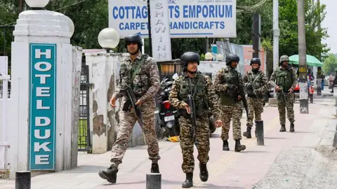 Getty Images Indian security forces patrol a road near Dal Lake in Srinagar, India, on May 6, 2025. Increased military presence follows the April 22 attack on tourists in Pahalgam, amid rising tensions between India and Pakistan.
