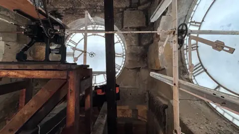Network Rail The interior workings of an old clock tower showing the clock face