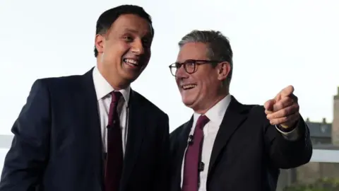 PA Media Sir Keir Starmer and Anas Sarwar laugh at an event in Scotland after Labour's general election victory 