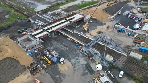 Northumberland County Council  An aerial view of a bridge being put in place over a railway line 