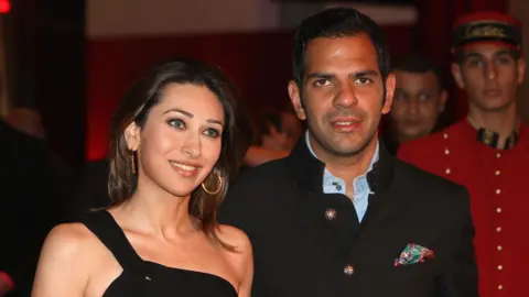 Getty Images Sanjay Kapur (R) and Karishma Kapur attend the opening of the new Cartier boutique in the Dubai Mall on March 26, 2009 in Dubai, United Arab Emirates. Cartier has officially opened the largest boutique in the Middle East at the prominent and luxurious Dubai Center