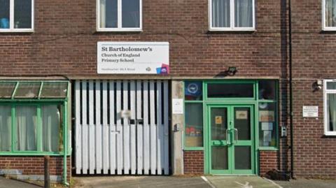 A google maps image of a brick building with green glazed windows and doors and a sign reading St Bartholomew's CE Primary school above the door