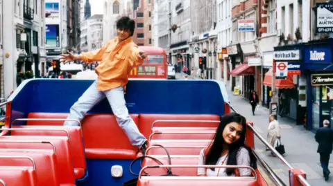 Yash Raj Films Shah Rukh Khan and Kajol in the film Dilwale Dulhania Le Jayenge sat on an open top bus in London. 
