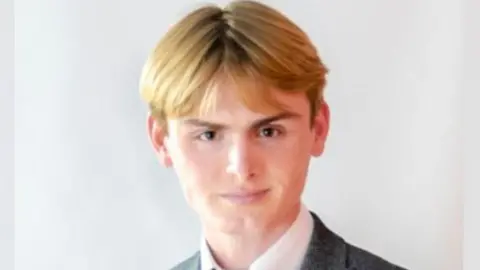 An official portrait of Macaulay Andrew Nichol, who is wearing a suit and tie.