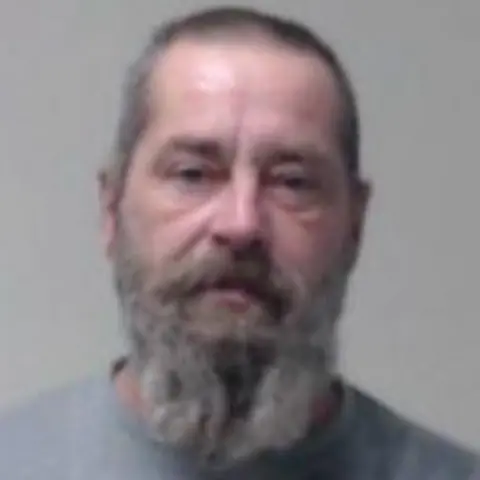 Police Scotland Waldemar Jaronski is a middle aged man with short grey hair and a bushy grey beard. 