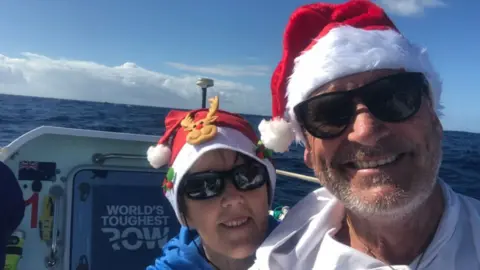 Nicky & Bob Parr The couple are on their boat in the sunshine and are wearing Christmas hats