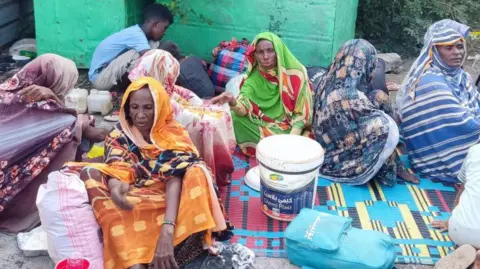 Getty Images Sudanese, displaced from the Gezeira district, arrive in the eastern city of Gedaref on 26 October 2024