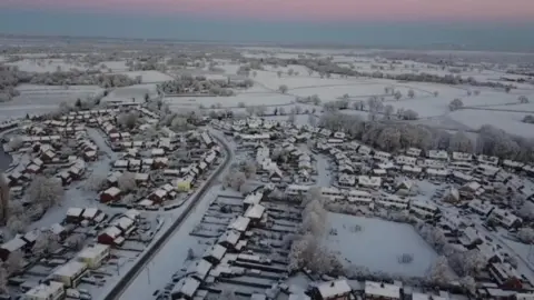 An aerial view of snow-covered homes in North Staffordshire