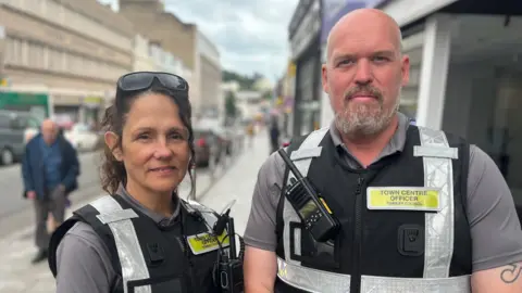 BBC Town Centre Officers wearing high-visibility vests with radios in Torquay town centre