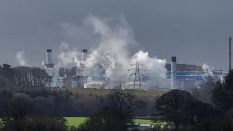 PA Landscape shop of nuclear power plant with smoky clouds in the air. 