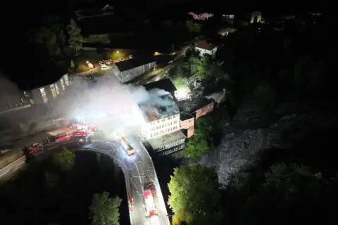 Graubünden cantonal police Aerial view of fire crews responding to the restaurant fire.