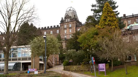 BBC Matlock County Hall, which houses Derbyshire County Council
Listed building with grey stone and large trees outside 