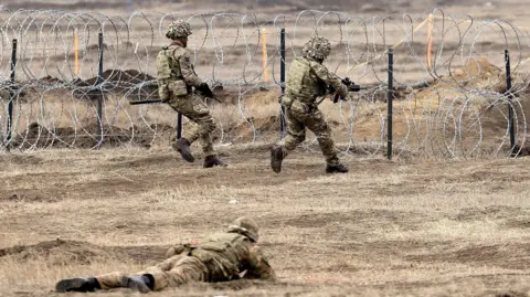 EPA NATO's Allied Reaction Force members approach barbed wire during the NATO exercise Steadfast Dart in Romania.