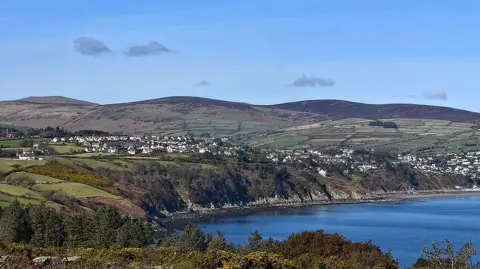 Laxey and Lonan see in the distance with Laxey Bay in the fore and hills behind.