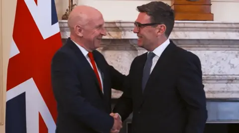 John Healey and Andy Burnham shake hands