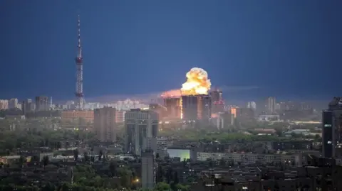 An explosion is seen above the Kyiv skyline