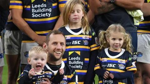 PA Media Rob Burrow with his children Macy, Maya and Jackson after the testimonial match at Emerald Headingley, Leeds on 12 January, 2020