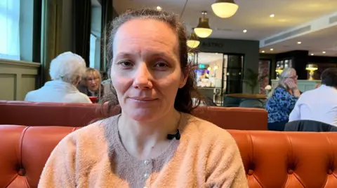 BBC Woman sat in a booth