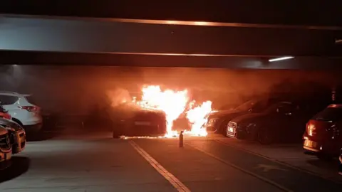 Bedfordshire Fire & Rescue Service A car caught fire inside a multi-storey car park. It is not parked in the bay. There was a fire extinguisher left on the floor. 