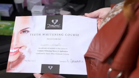 "Teeth Whitening Course. This is to certify that Laura O'Neill has attended all modules on the course on Cosmetic Whitening Theory and Application. Conducted by Pearly White Diamonds Training. Date 15/09/2025." The instructor's signature, which is pixelated in the image, is on the right-hand side.