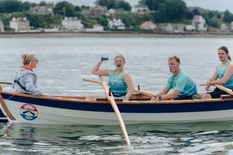 Kirstin McEwan A rower celebrates victory on Loch Ryan by punching the air 