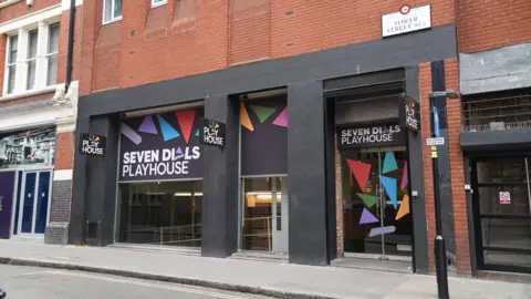 Seven Dials Playhouse exterior with black backdrop and blue, red and purple triangles