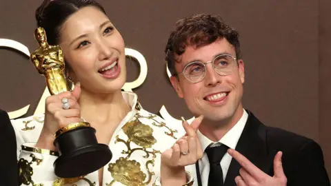 Golden songwriters Ejae and Mark Sonnenblick winners of the Best Original Song for "Golden" from “KPop Demon Hunters" pose in the press room during the 98th Oscars at Dolby Theatre.