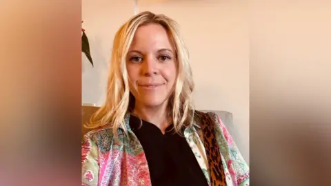 A woman in a colourful jacket. 