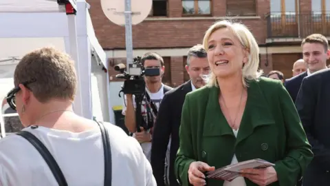 DENIS CHARLET/AFP Marine Le Pen out campaigning in June 2024