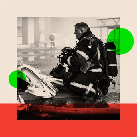 Getty Images Firefighter remove rubble from destroyed hypermarket