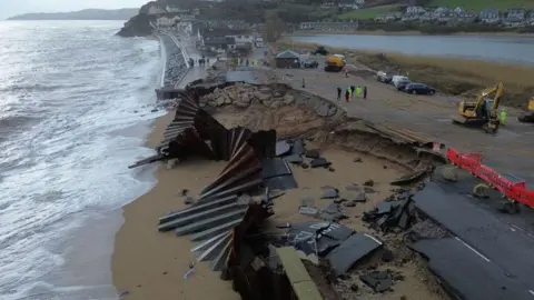 The A379 Slapton Line between Torcross and Slapton has washed away. The image shows a gaping hole in the street.