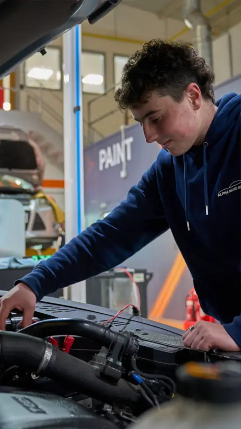 Apprentice, Liam Woodham, working on a car at Thatcham Research.