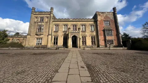 Georgian style castle infront of pebbled grounds