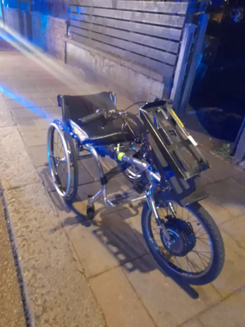 Israel Vidal A wheelchair with an extra wheel attached to the front of it