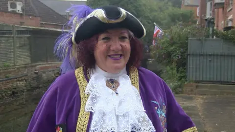 Bognor Regis town crier Jane Smith dressed in a purple gown