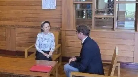 Myanmar Military Information Committee Former Myanmar president Aung San Suu Kyi talks to an official from the International Committee of the Red Cross