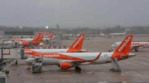 Easyjet planes on the tarmac at Gatwick airport.