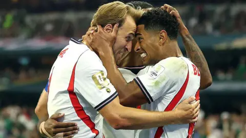 Getty Images Jude Bellingham of England celebrates scoring his team's second goal with Harry Kane during the FIFA World Cup 2026 Round of 16 match between Mexico and England at Mexico City Stadium on July 05, 2026 in Mexico City. The players are hugging each other. 